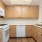 a kitchen with wooden cabinets