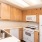 a kitchen with wooden cabinets