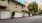 a building with garages and trees in the background