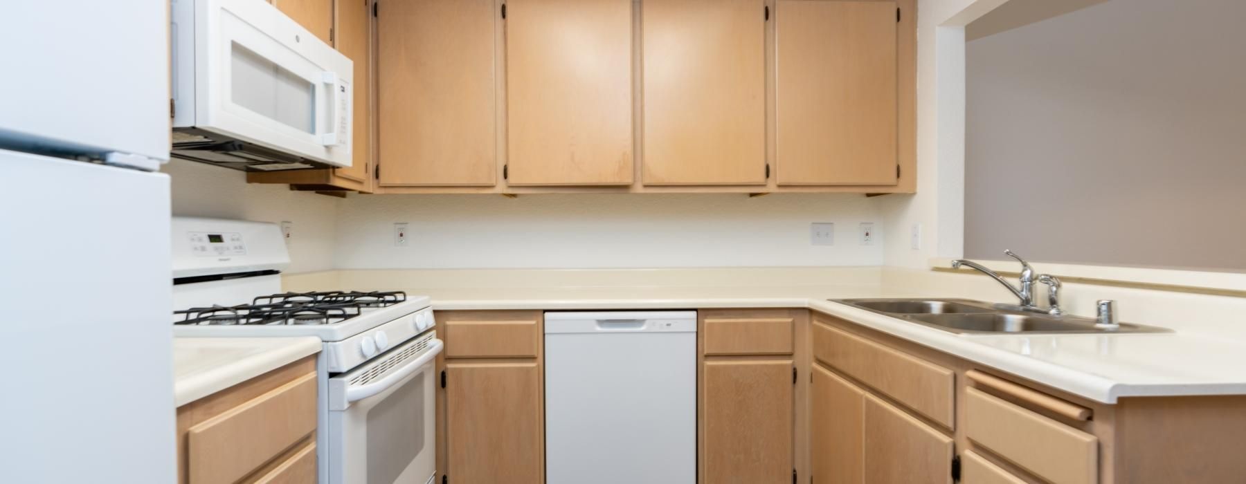 a kitchen with wooden cabinets